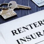 Renters Insurance policy agreement and key from apartments.